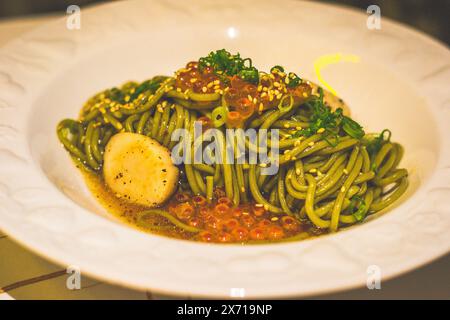 Ocha-infused Buckwheat Noodle Soba with Scallops and Truffle Sauce in a bowl Stock Photo