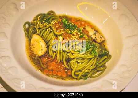 Ocha-infused Buckwheat Noodle Soba with Scallops and Truffle Sauce in a bowl Stock Photo