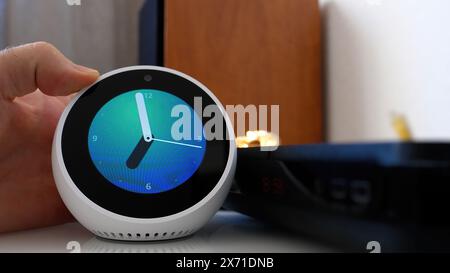 Paris, France - Jun 5th, 2020: The Amazon Echo Spot shows a clock on its screen, featuring a clean and modern interface Stock Photo