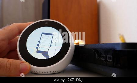 Paris, France - Jun 5th, 2020: The installation screen of an Amazon Alexa smart assistant from Amazon Corporation displays Routines text, indicating the setup of automated tasks and personalized features Stock Photo