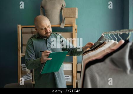 Adult aspiring small business owner checking customer's order. Internet sales, e-commerce, delivery concept Stock Photo