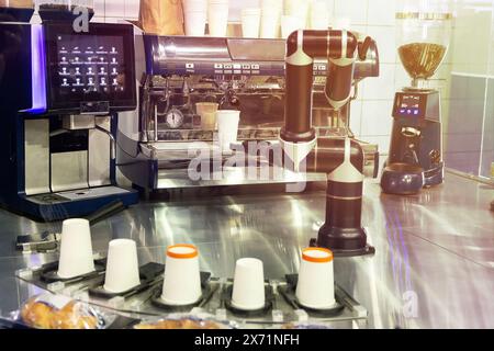 Robot with artificial intelligence making coffee on coffee machine. Food and drink Stock Photo