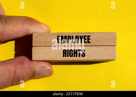 Employee rights words written on wooden blocks with yellow background. Conceptual employee rights symbol. Copy space. Stock Photo