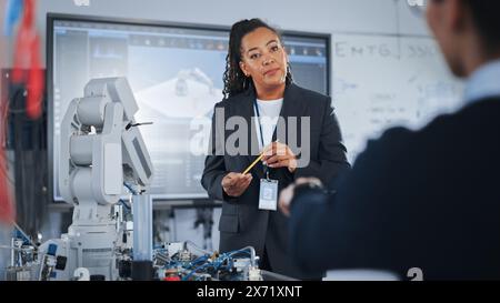 Chief Engineer Presents Innovative Robot Arm to Start-up at Conference. Futuristic Design of AI Robot Hand, Helping to Automate Factory Working. Advanced Robotics Technology Concept. Stock Photo