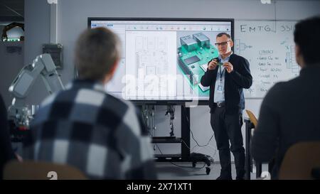 Confident Male Teacher Using Digital Interactive Whiteboard, Talking to Group of Diverse Students and Showing 3D Printed Circuit Board Concept. Education and Advanced Technology. Stock Photo