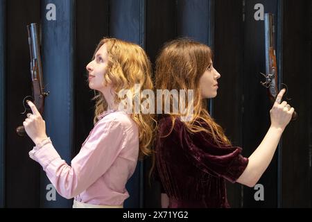 London, England, UK. 17th May, 2024. Bonhams staff members hold a fine pair of 32-bore flintlock duelling pistols by Samuel Henry Staudenmeyer, London, circa 1810, during an Antique Arms and Armour sale preview at Bonhams Knightsbridge. (Credit Image: © Thomas Krych/ZUMA Press Wire) EDITORIAL USAGE ONLY! Not for Commercial USAGE! Stock Photo