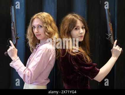 London, England, UK. 17th May, 2024. Bonhams staff members hold a fine pair of 32-bore flintlock duelling pistols by Samuel Henry Staudenmeyer, London, circa 1810, during an Antique Arms and Armour sale preview at Bonhams Knightsbridge. (Credit Image: © Thomas Krych/ZUMA Press Wire) EDITORIAL USAGE ONLY! Not for Commercial USAGE! Stock Photo