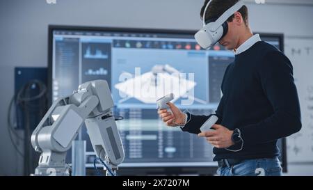 Mechanical Engineer Student Wearing Virtual Reality Headset and Holding Controllers, Uses VR technology for Industrial Design, Development, Prototyping in Robotics. High Tech Concept Stock Photo