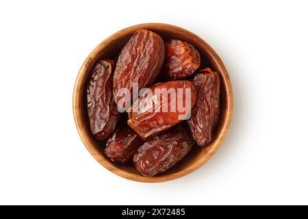 Dried dates in wooden bowl on white background Stock Photo