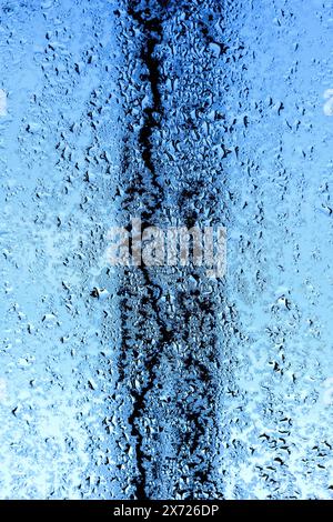 Early morning condensation and raindrops on Velux roof window. Stock Photo