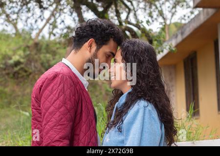 lifestyle: young latin couple face to face looking in love and smiling at each other Stock Photo