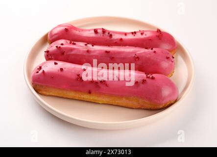 Delicious eclairs covered with glaze on white background, Stock Photo