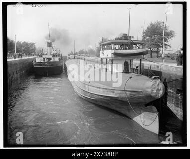 Sault Ste. Marie, Mich., whaleback barge in Weitzel Lock, Title from jacket., G 4566' on negative., Boat at left: Mariska of Duluth, a steam screw. Boat at right is a whaleback barge, with part of name visible '131 , . of Duluth.' The whaleback barge 131, was built at Superior, Wisconsin in 1893., Detroit Publishing Co. no. 036261., Gift; State Historical Society of Colorado; 1949,  Mariska (Ship) , Whalebacks. , Locks (Hydraulic engineering) , United States, Michigan, Sault Sainte Marie. , United States, Michigan, Sault Sainte Marie Canal. Stock Photo