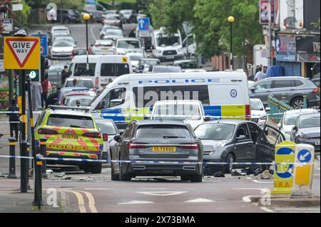 Clevedon Road, Birmingham, May 17th 2024 - West Midlands Police have closed several roads in the Balsall Heath area of Birmingham after a police chase led to the fleeing driver of a Nissan Micra to crash into another vehicle. One male occupant of the Micra was seriously injured and taken to hospital under arrest. Two other men fled the scene, one was arrested a short time later and the other is outstanding. Officers flooded the area of Clevedon Road and Lincoln Street setting up a large cordon. A mens trainer and black jacket along with first aid could be seen on the road at a pedestrian cross Stock Photo