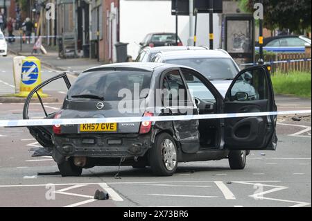 Clevedon Road, Birmingham, May 17th 2024 - West Midlands Police have closed several roads in the Balsall Heath area of Birmingham after a police chase led to the fleeing driver of a Nissan Micra to crash into another vehicle. One male occupant of the Micra was seriously injured and taken to hospital under arrest. Two other men fled the scene, one was arrested a short time later and the other is outstanding. Officers flooded the area of Clevedon Road and Lincoln Street setting up a large cordon. A mens trainer and black jacket along with first aid could be seen on the road at a pedestrian cross Stock Photo