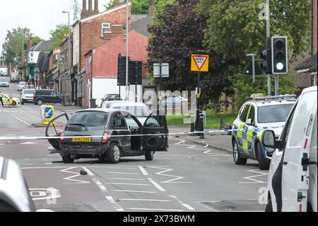 Clevedon Road, Birmingham, May 17th 2024 - West Midlands Police have closed several roads in the Balsall Heath area of Birmingham after a police chase led to the fleeing driver of a Nissan Micra to crash into another vehicle. One male occupant of the Micra was seriously injured and taken to hospital under arrest. Two other men fled the scene, one was arrested a short time later and the other is outstanding. Officers flooded the area of Clevedon Road and Lincoln Street setting up a large cordon. A mens trainer and black jacket along with first aid could be seen on the road at a pedestrian cross Stock Photo