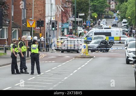 Clevedon Road, Birmingham, May 17th 2024 - West Midlands Police have closed several roads in the Balsall Heath area of Birmingham after a police chase led to the fleeing driver of a Nissan Micra to crash into another vehicle. One male occupant of the Micra was seriously injured and taken to hospital under arrest. Two other men fled the scene, one was arrested a short time later and the other is outstanding. Officers flooded the area of Clevedon Road and Lincoln Street setting up a large cordon. A mens trainer and black jacket along with first aid could be seen on the road at a pedestrian cross Stock Photo