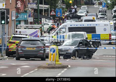 Clevedon Road, Birmingham, May 17th 2024 - West Midlands Police have closed several roads in the Balsall Heath area of Birmingham after a police chase led to the fleeing driver of a Nissan Micra to crash into another vehicle. One male occupant of the Micra was seriously injured and taken to hospital under arrest. Two other men fled the scene, one was arrested a short time later and the other is outstanding. Officers flooded the area of Clevedon Road and Lincoln Street setting up a large cordon. A mens trainer and black jacket along with first aid could be seen on the road at a pedestrian cross Stock Photo