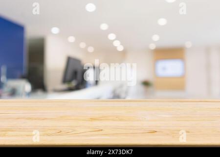 Wood table with Abstract blur office desk workplace with computer defocused background Stock Photo