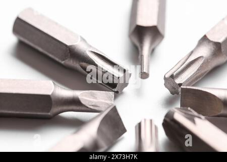 Different screwdriver bits on white background, closeup Stock Photo