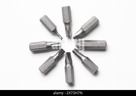 Different screwdriver bits on white background, top view Stock Photo
