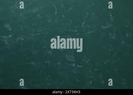 Chalk rubbed out on green chalkboard as background, closeup. Space for text Stock Photo