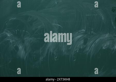 Chalk rubbed out on green chalkboard as background, closeup. Space for text Stock Photo