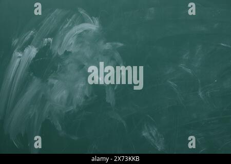 Chalk rubbed out on green chalkboard as background, closeup. Space for text Stock Photo