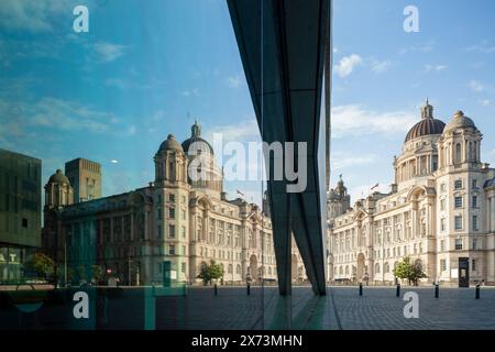 Port of Liverpool building reflecting in the facade of Museum of Liverpool. Stock Photo