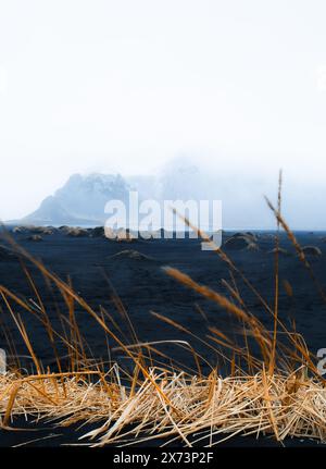 Dramatic moody Stokksnes black beach in South East Iceland. Dramatic cold rainy stormy day in extreme conditions weather Stock Photo