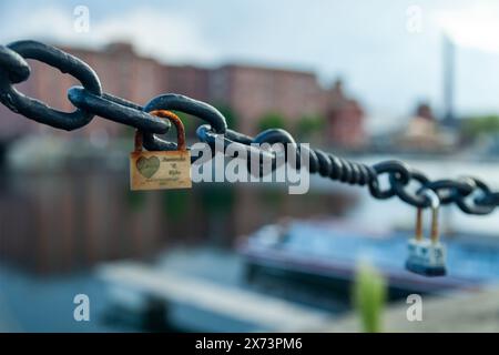 Padlocks on chain along Salthouse Dock in Liverpool. Stock Photo