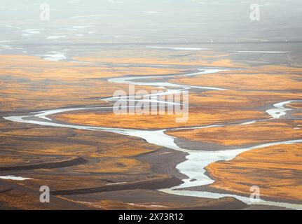 Top view of abstract blue glacier rivers pattern flowing through volcanic moss field in Icelandic highlands on summer Stock Photo