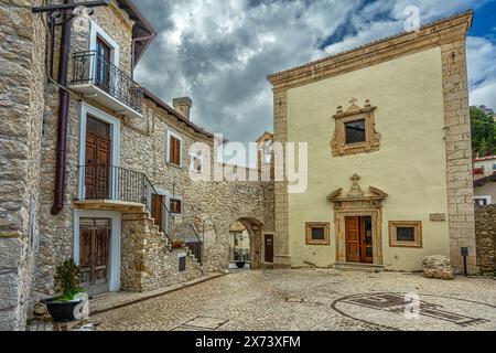 Facade of the church of San Rocco with the small square of the same name and the main gate of the city walls. Castel del Monte, Abruzzo Stock Photo