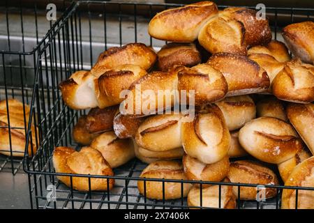 Freshly baked rolls in a black metal basket Stock Photo