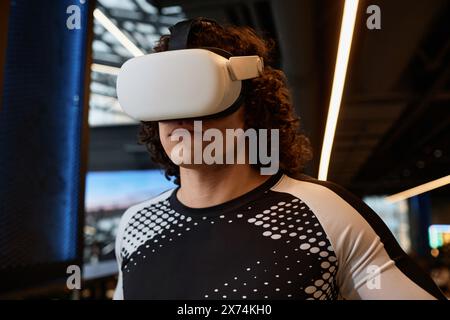Portrait of young man wearing VR gear during sports workout in futuristic gym copy space Stock Photo