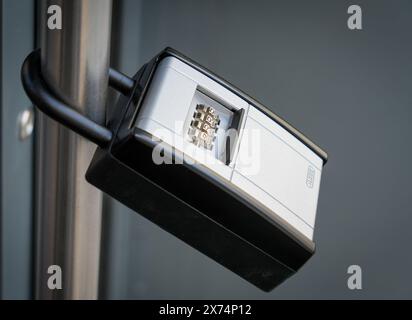 Berlin, Germany. 08th May, 2024. A key box secured with a numerical code is attached to the outside of the entrance door to an apartment building. Such boxes are used by landlords for vacation apartments. This allows the landlord to organize the arrival of guests flexibly without having to be on site himself. Credit: Soeren Stache/dpa/Ģ����ý Live News Stock Photo