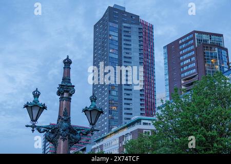 City view with modern skyscrapers and an old lamp post in the foreground under a blue sky, small harbour in a big city with a lighthouse and modern Stock Photo