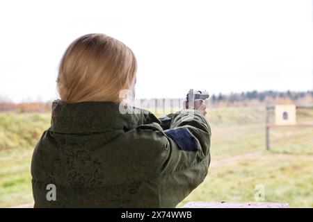 Man shooting at a target. Unformal shooting range  Stock Photo