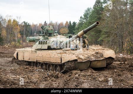 Russian tank rides on a forest road Stock Photo