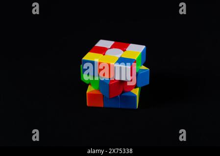 Salvador, Bahia, Brazil - May 15, 2024: Classic 3x3x3 Rubiks Cube on a black background. Rubiks Cube invented by Hungarian architect Erno Rubik in 197 Stock Photo
