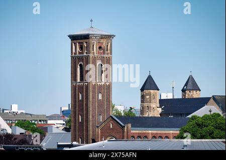 tower of the trinitatis church one of the first newly built protestant churches in cologne, in the background the towers of St Maria im Kapitol Stock Photo