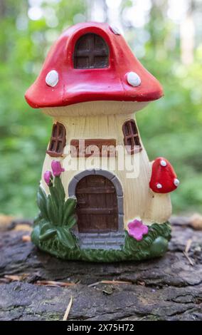 Collection of birdhouses made by children and placed on fallen trees in the forest. Stock Photo