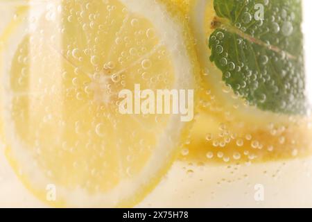 Freshly made lemonade with mint in jug as background, closeup Stock Photo