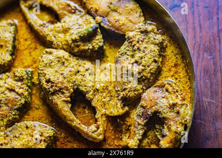 Sorshe ilish or hilsa fish curry cooked with mustard seeds. It is a very famous Bengali dish. Pieces of fish are seen in rich yellow gravy. This is tr Stock Photo