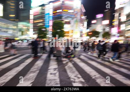 Crowds of people having fun in the evening at the famous Shibuya crossing in Tokyo Stock Photo