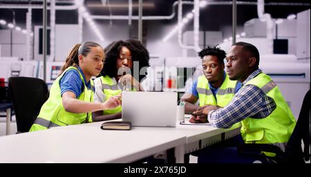 Team Of Engineers Talking At Industrial Workplace Stock Photo