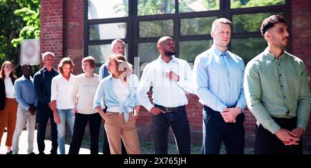 Queue Outdoors. Business People Waiting In Line Stock Photo