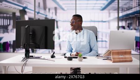 Employee Working On Desktop Computer In Home Office Stock Photo