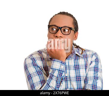 Portrait of an anxious young man biting his nails fingers freaking out Stock Photo