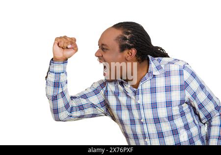 Side profile portrait of a young angry man screaming Stock Photo
